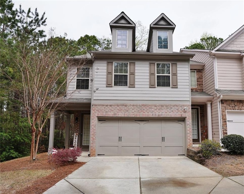 View of front of home featuring brick siding, conc