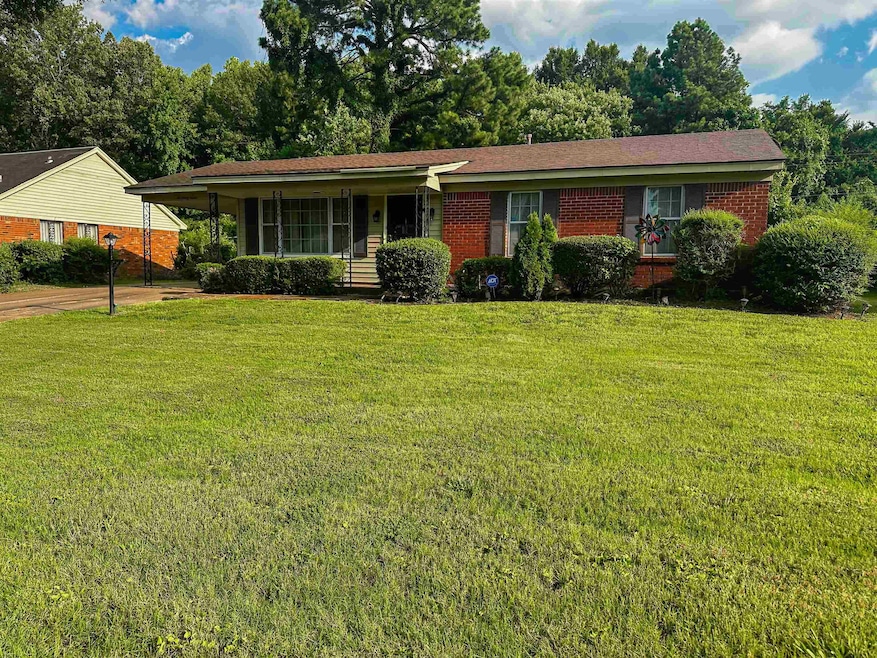 Single story home featuring a porch and a front la