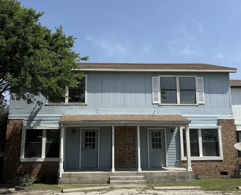 Townhome / multi-family property with a porch and
