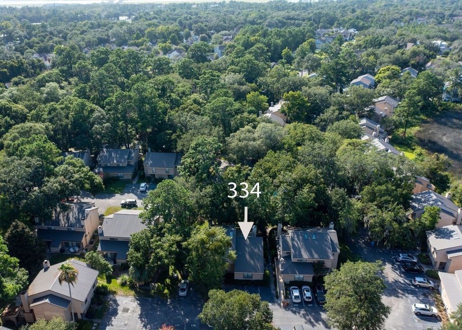 front door parking, pool is covered up by trees in