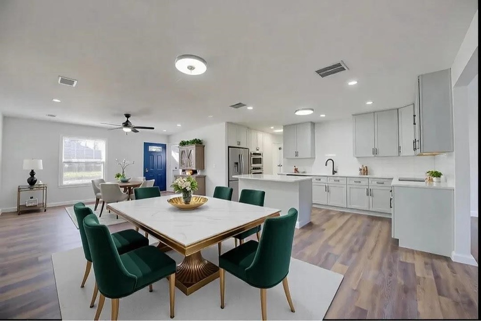 Dining room featuring ceiling fan, sink, and light