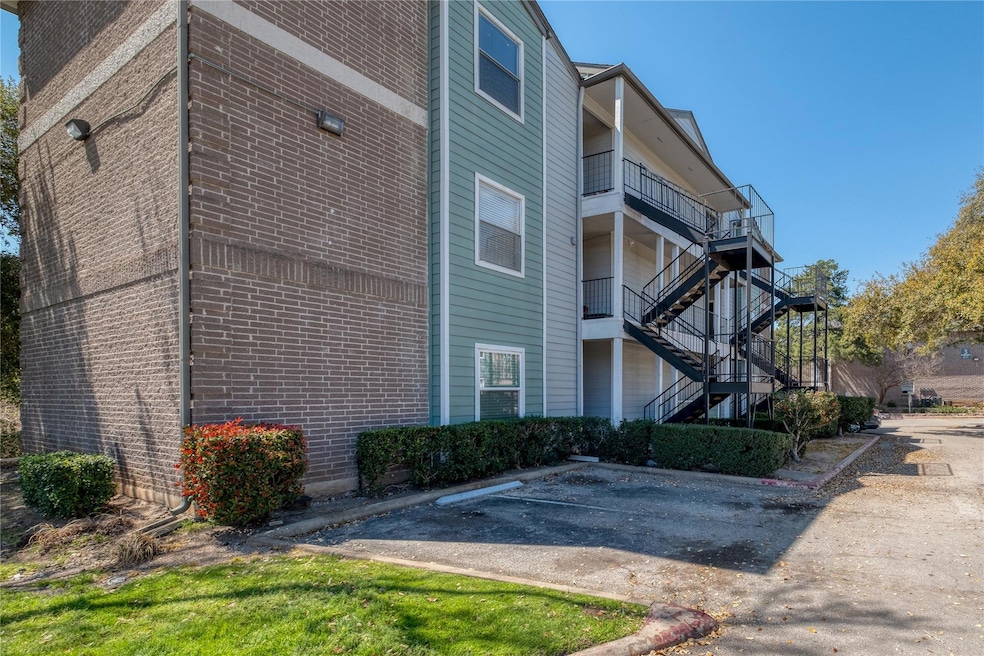 View of side of home with uncovered parking, stai