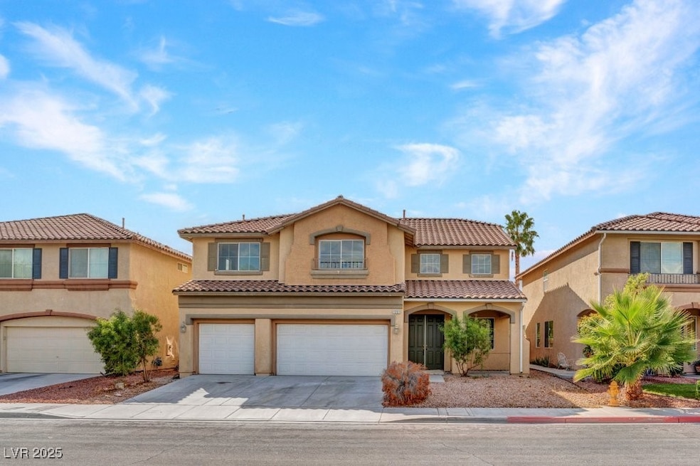 Mediterranean / spanish home with stucco siding, driveway, an attached garage, and a tiled roof
