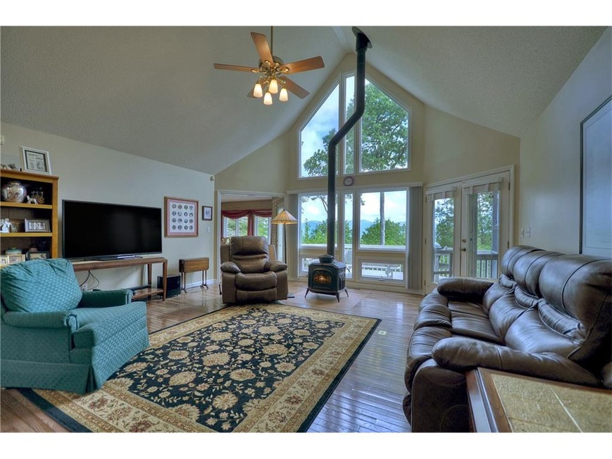 Great room view through wall of windows to deck an