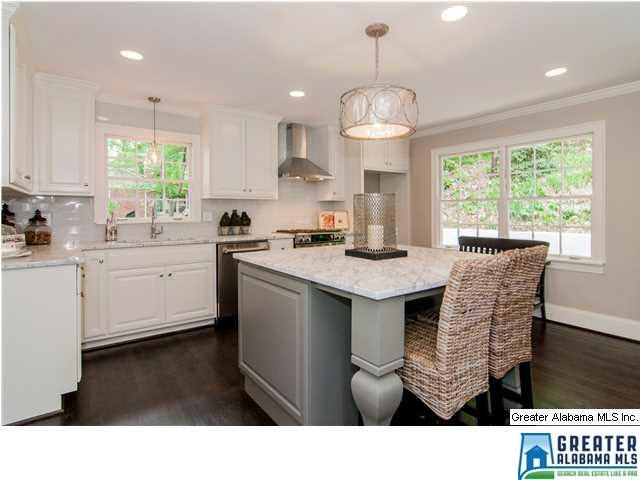 Custom kitchen features a large island with seatin