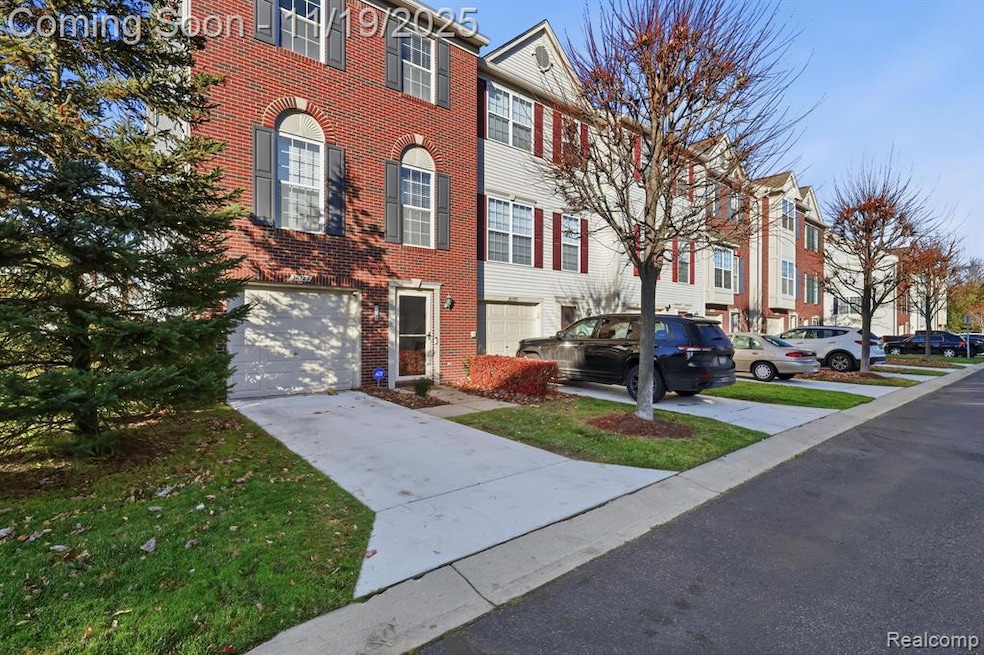 View of front of house with driveway and brick siding