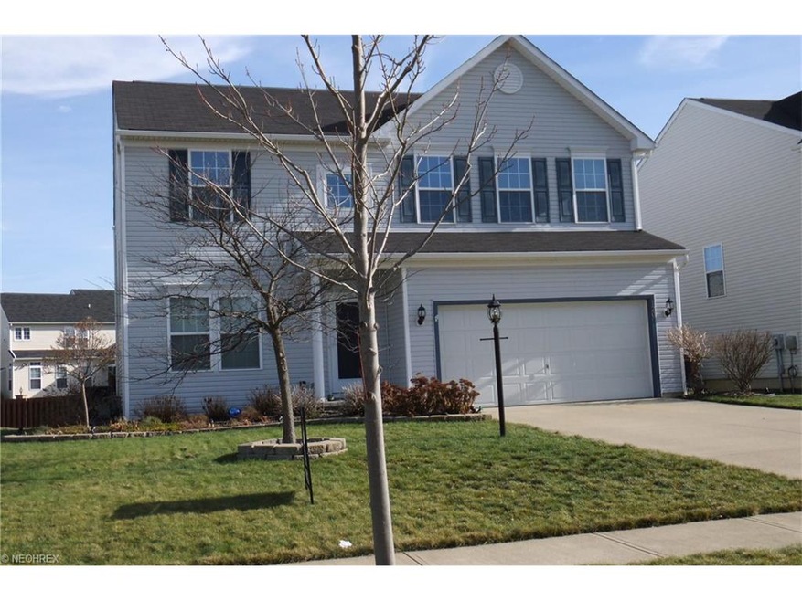 Vinyl siding, covered front stoop, cement driveway