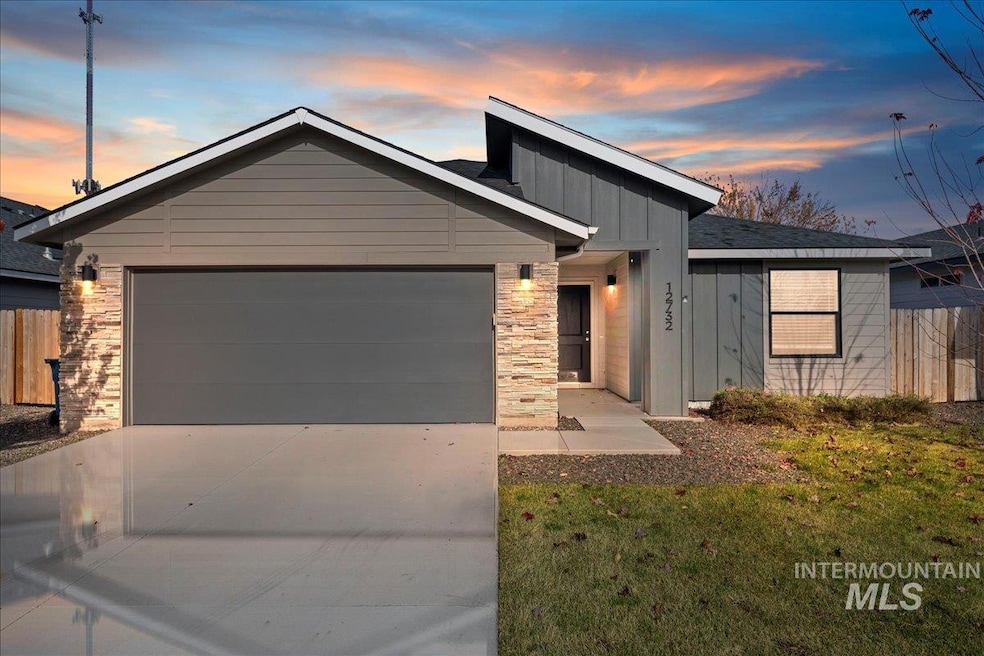 View of front of house with board and batten siding, concrete driveway, and an attached garage