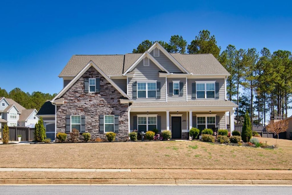 Craftsman inspired home featuring stone siding and