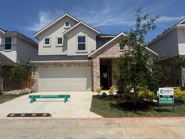 View of front of property featuring a garage, con