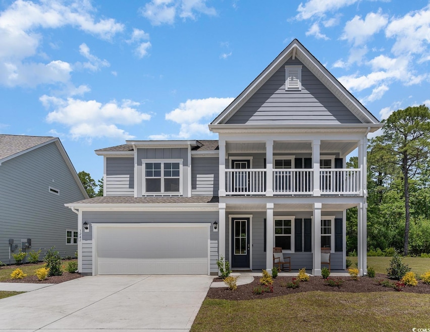 View of front of house with a porch, a garage, a b