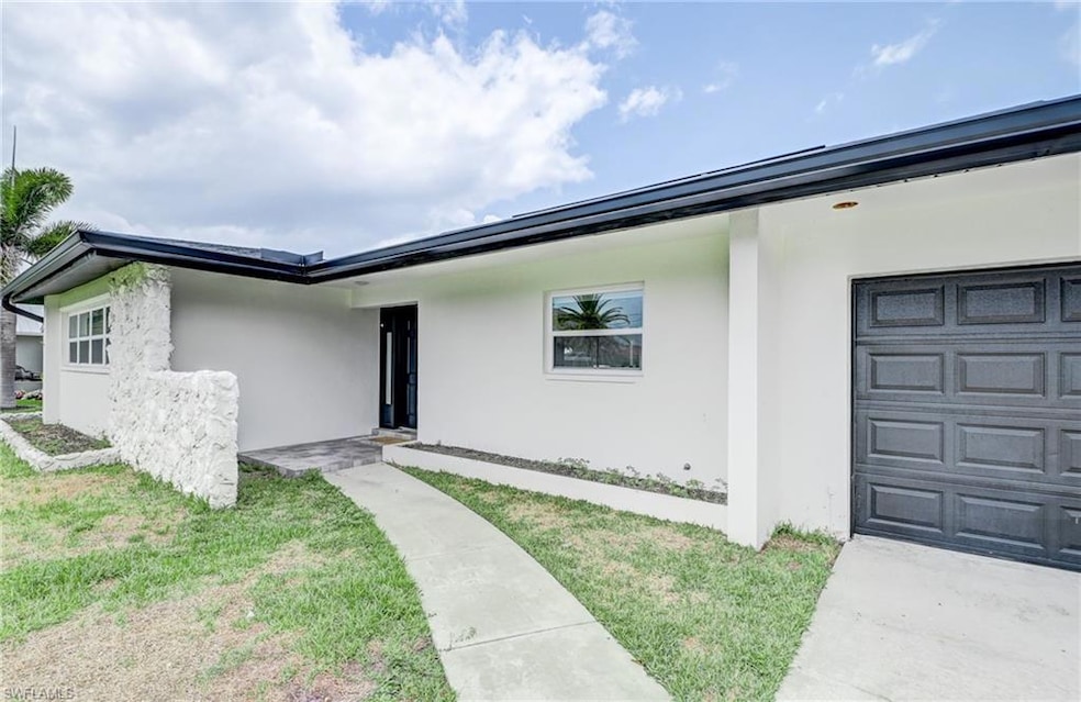 Doorway to property featuring an attached garage a
