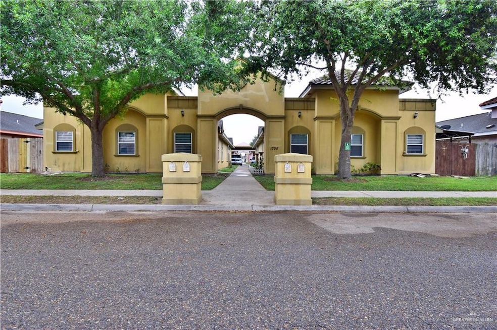 Mediterranean / spanish-style home with fence, a front lawn, and stucco siding