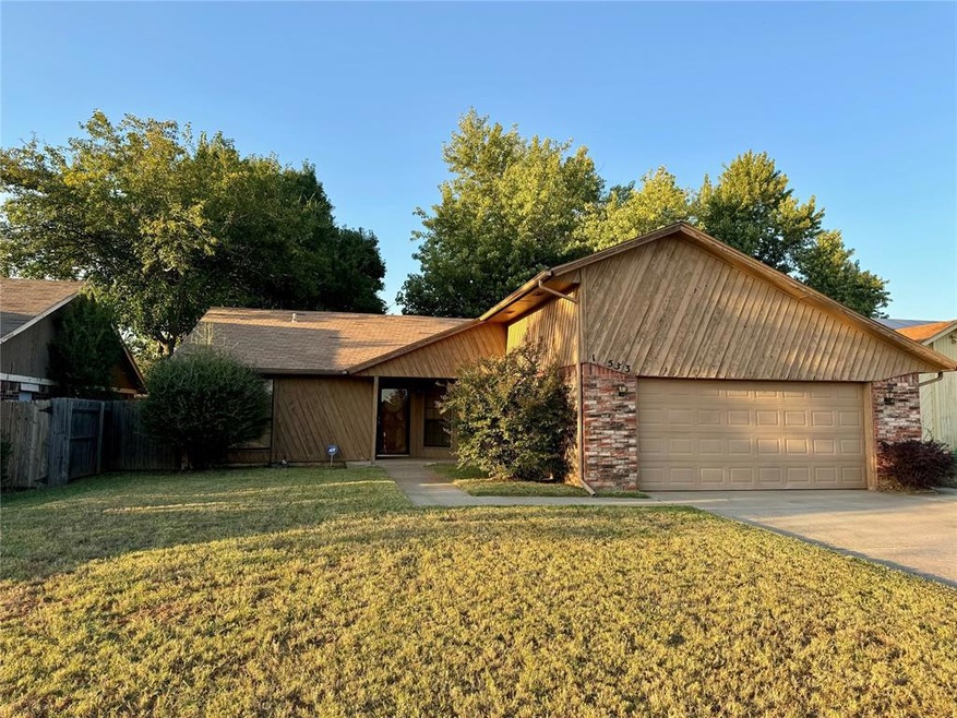 Ranch-style home with a garage and a front lawn
