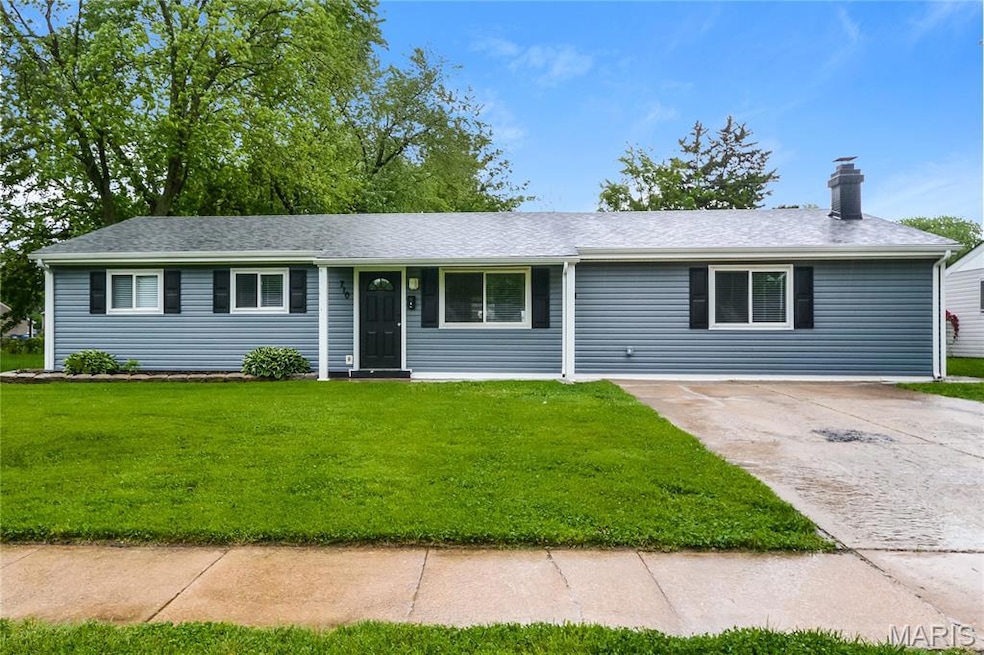 Ranch-style home featuring concrete driveway, a chimney, a front yard, and a shingled roof