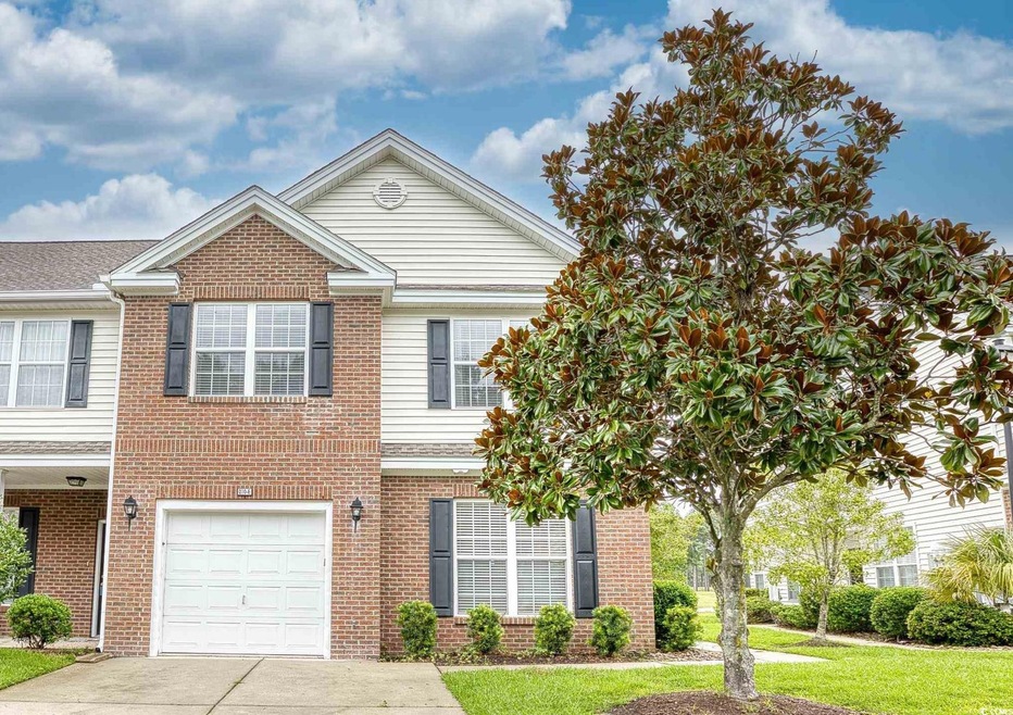View of front of property featuring a garage and a