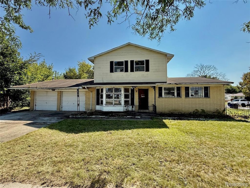 Traditional-style home featuring brick siding, a front lawn, a porch, and driveway