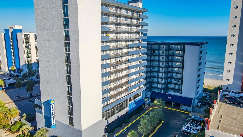 View of property with a water view