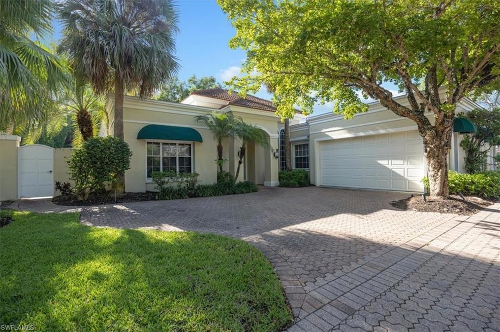 Mediterranean / spanish house with decorative driveway, stucco siding, an attached garage, and a tiled roof