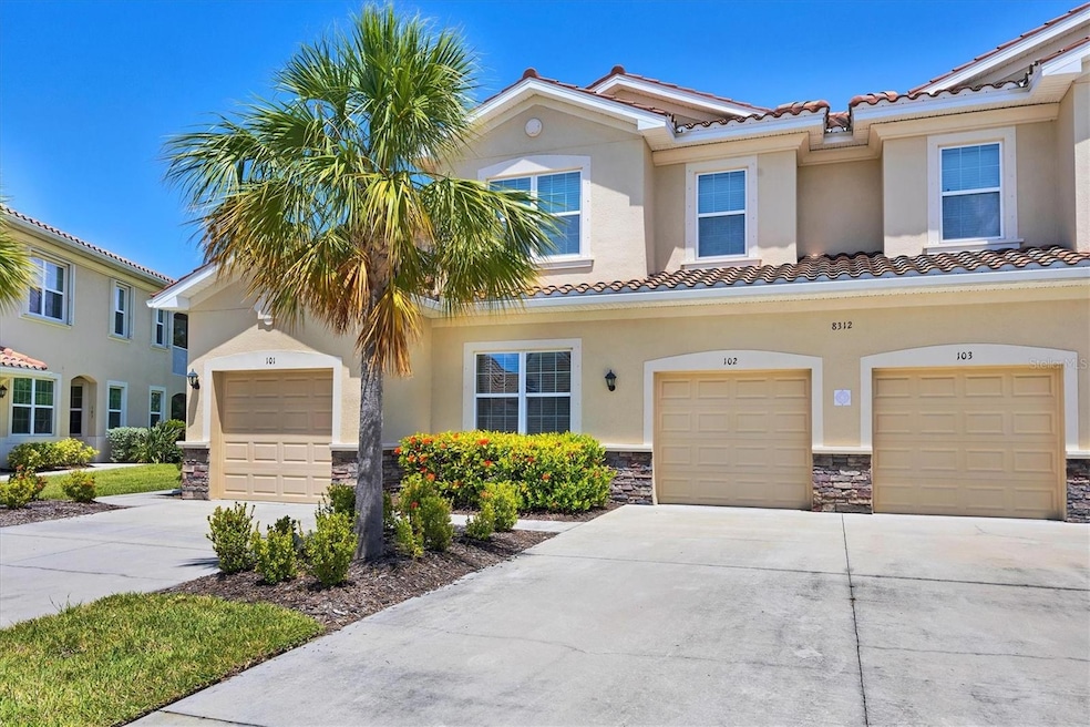 Front view of the home featuring the one car garage and landscaping
