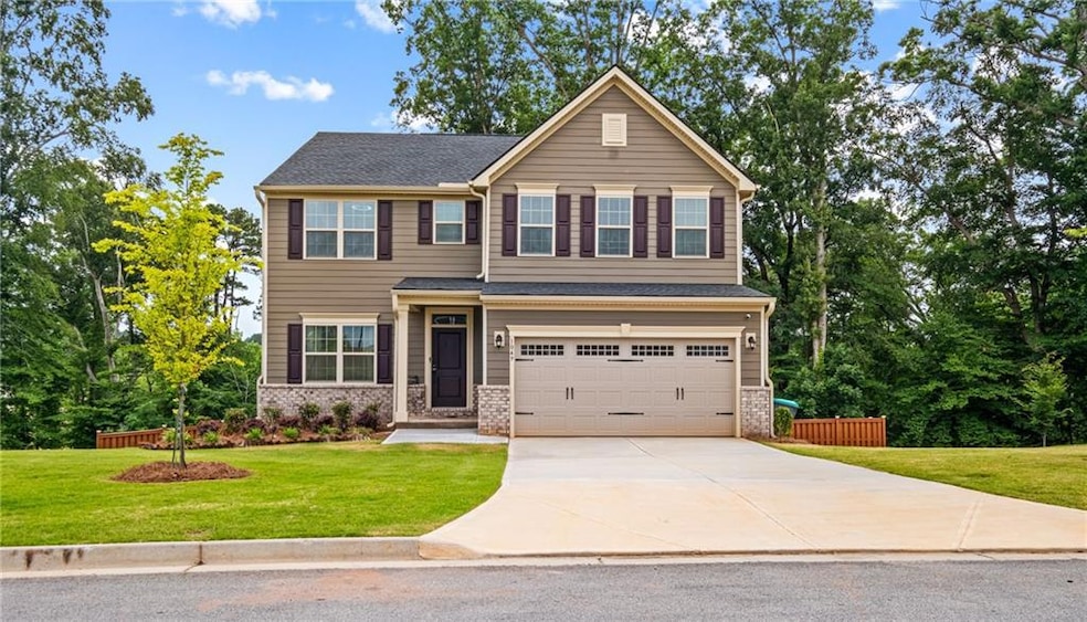 Craftsman house with a garage, concrete driveway, and a front yard