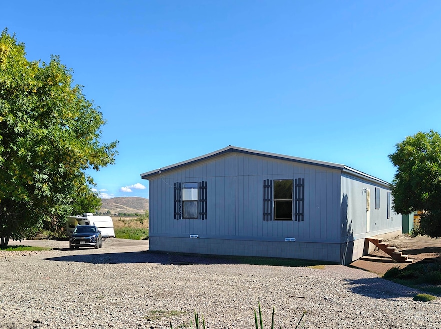 View of side of property with crawl space and a mountain view
