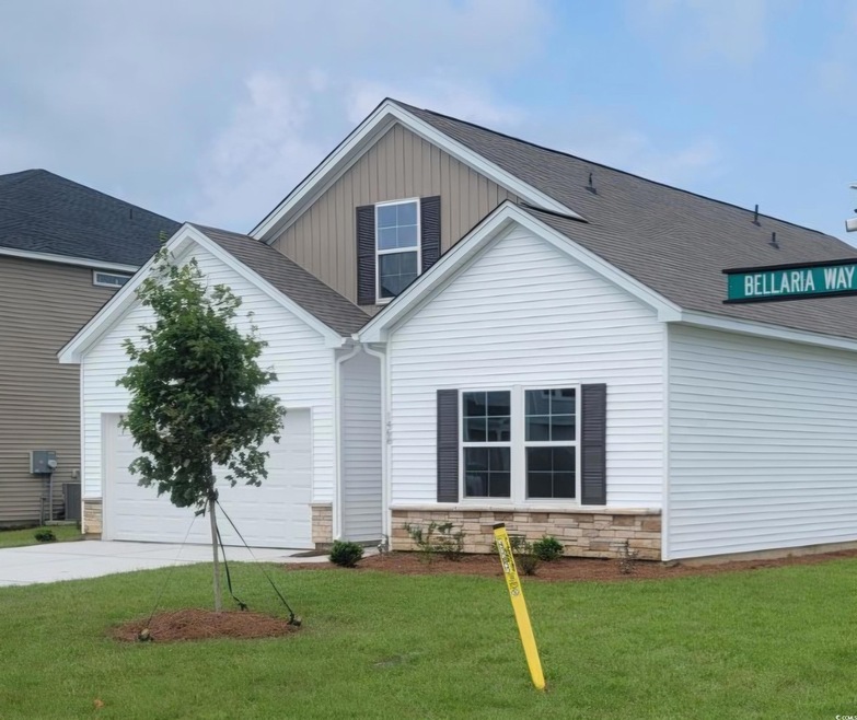 Exterior space featuring a front yard and a garage