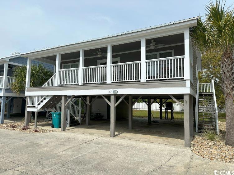 View of front of home featuring a carport and ceil