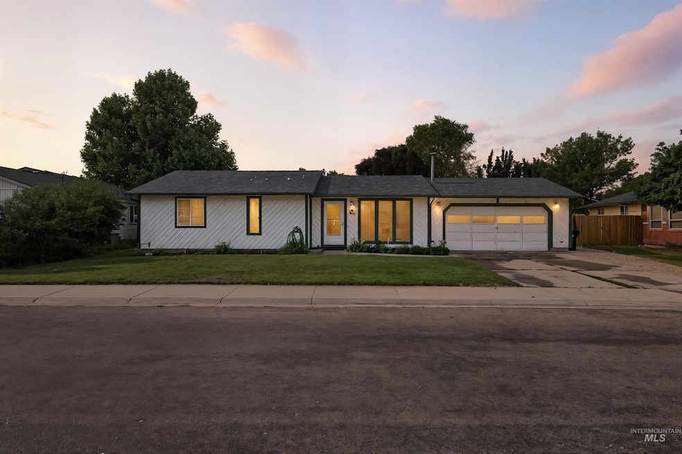 View of front of house with an attached garage and concrete driveway