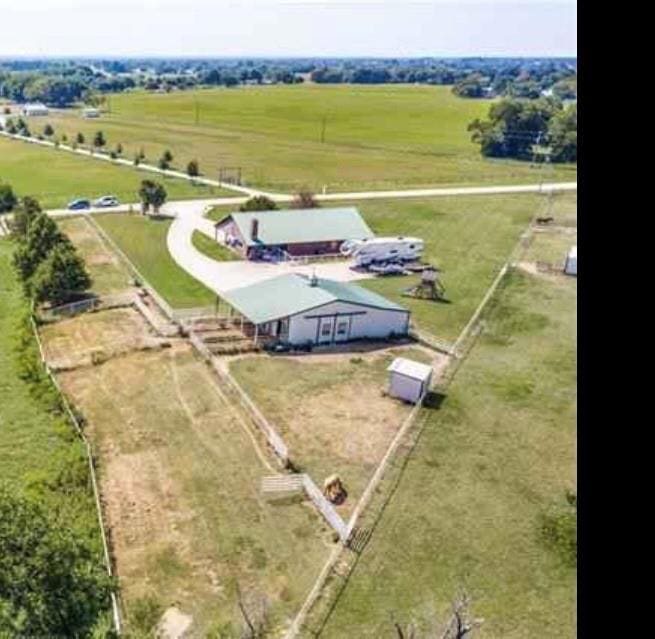 Birds eye view of property featuring a rural view