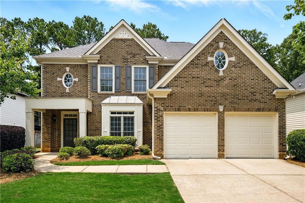 View of front of house with driveway, an attached garage, brick siding, and a front yard