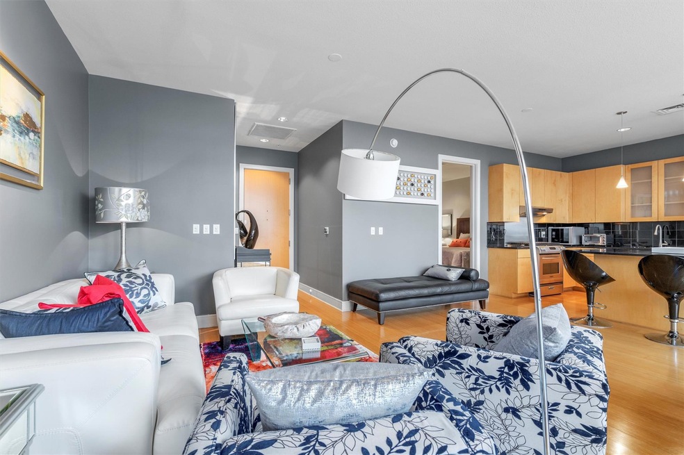 Living room with light wood-style flooring and ba