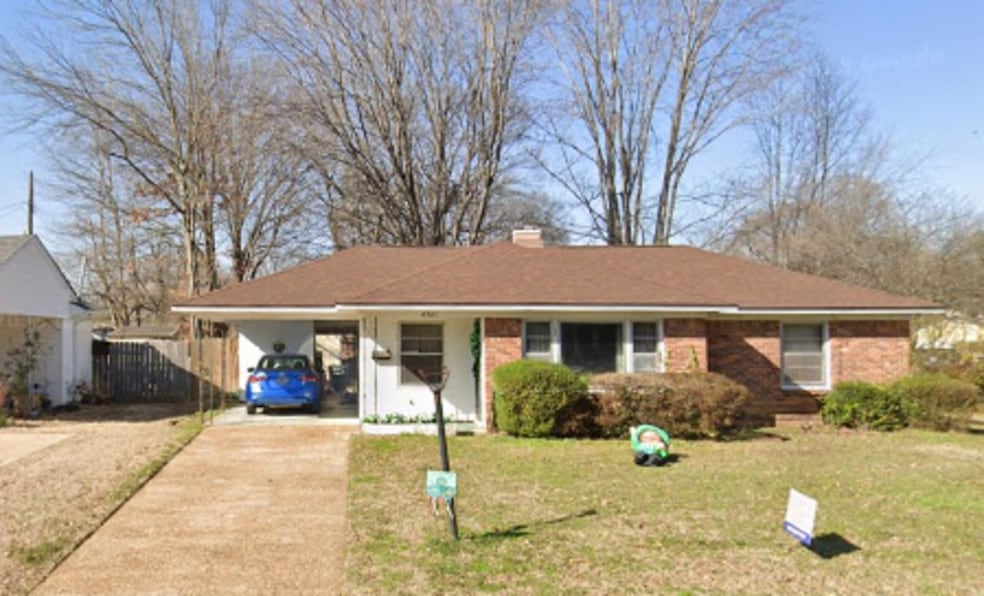 Ranch-style home with driveway, an attached carport, and a chimney