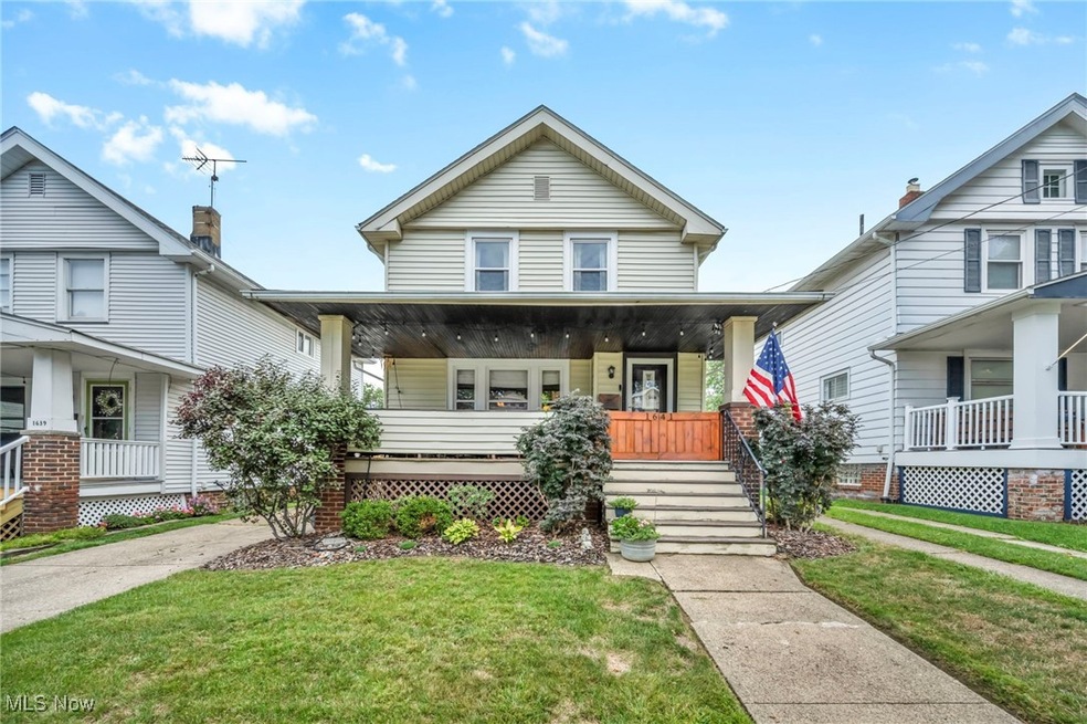 View of front of property with a front lawn and covered porch