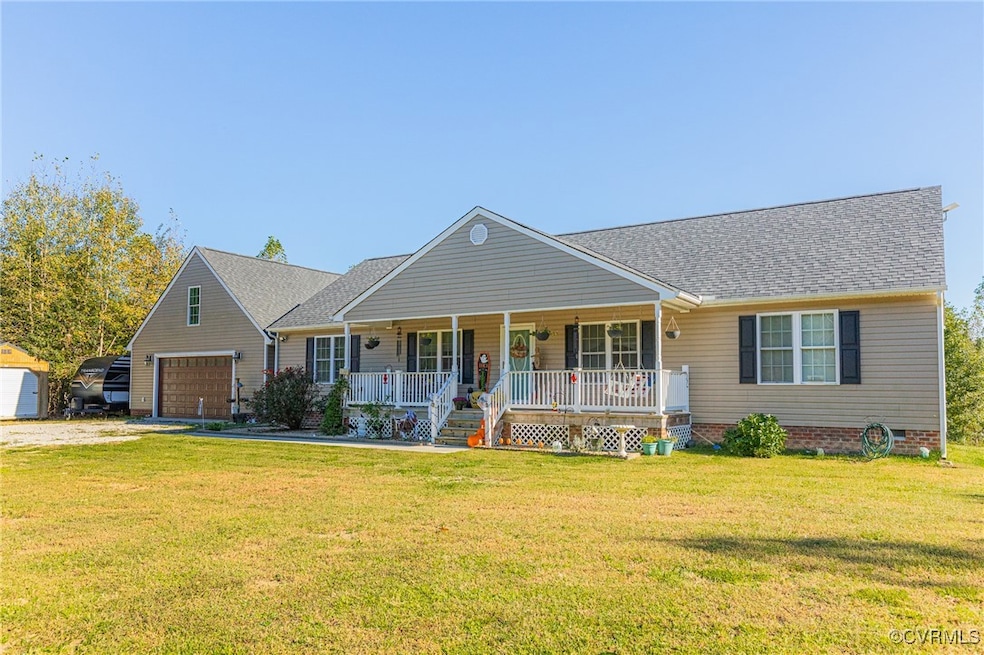 Ranch-style home with a garage, a front lawn, and