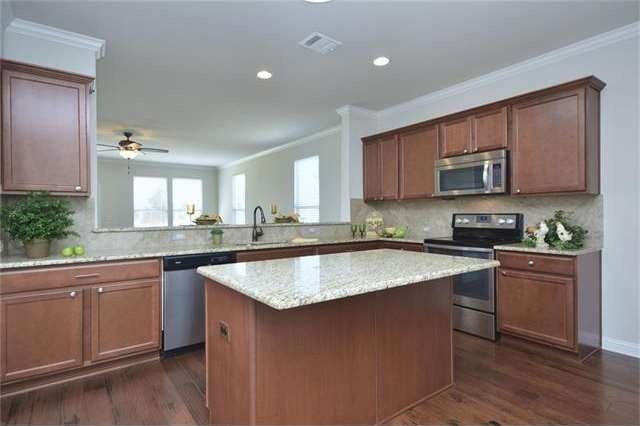 A wide granite breakfast bar makes the perfect prep area.