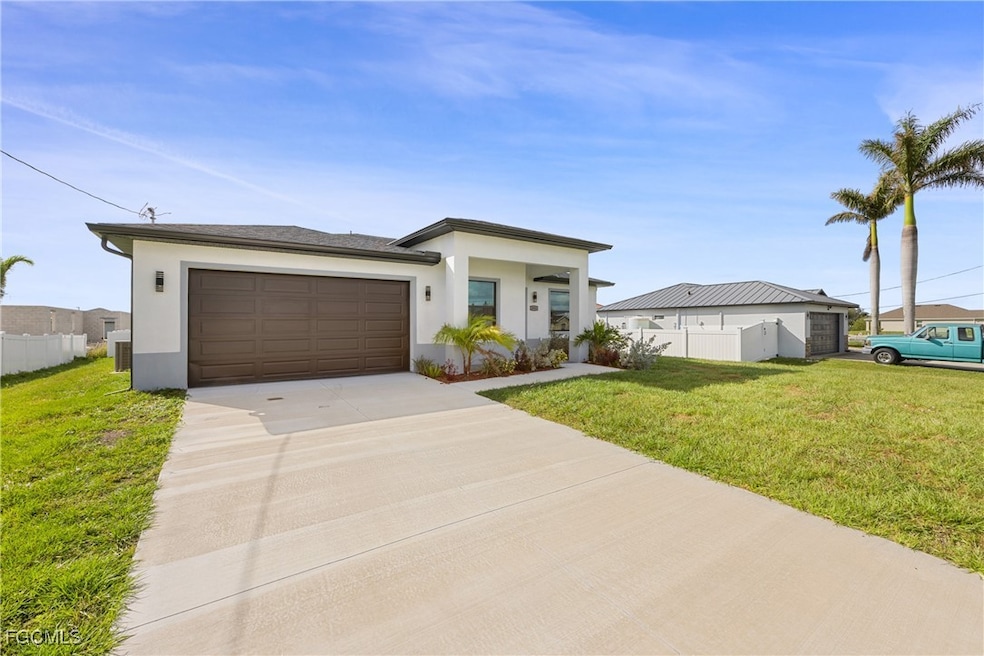 View of front of property featuring stucco siding, concrete driveway, and an attached garage
