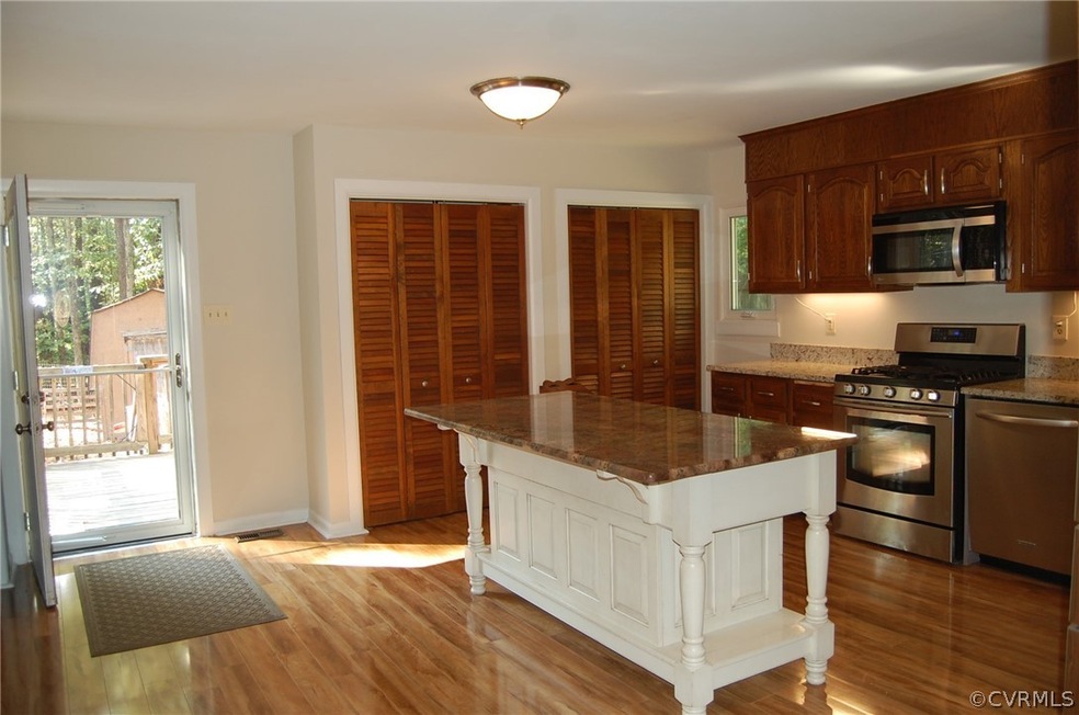 This is HOME. Imagine your fun in this HUGE, bright kitchen with propane cooking, tons of counter and cabinet space, and pantry closets! Enjoy this gorgeous flooring and a beautiful island with more storage! The kitchen has freshly painted walls and ceilings! All you have to do is enjoy it!