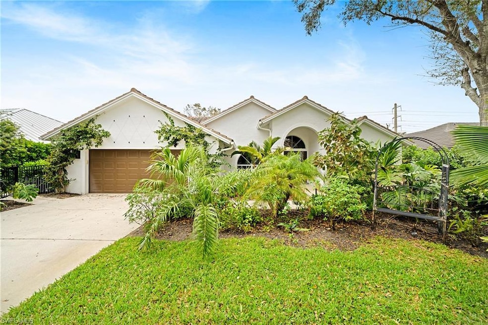 View of front of home with a garage and a front ya