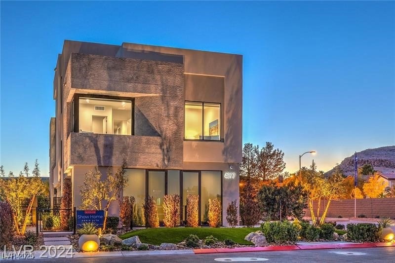 Back of property with a mountain view and stucco s