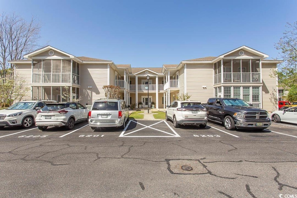 View of building exterior with uncovered parking