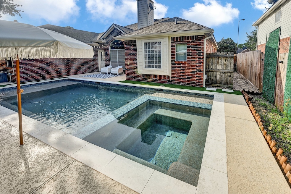 Enjoy a stunning backyard oasis featuring a sparkl