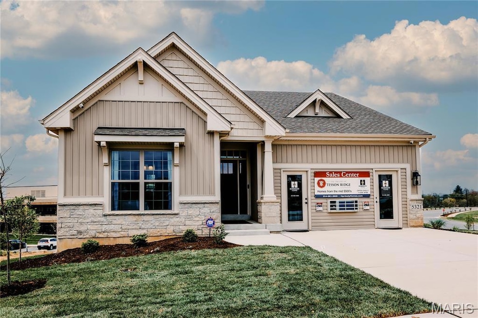 Craftsman-style house with stone siding, a front lawn, board and batten siding, and a shingled roof