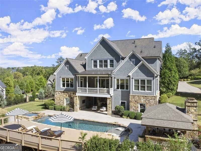 Rear view of property featuring a gazebo, a patio 