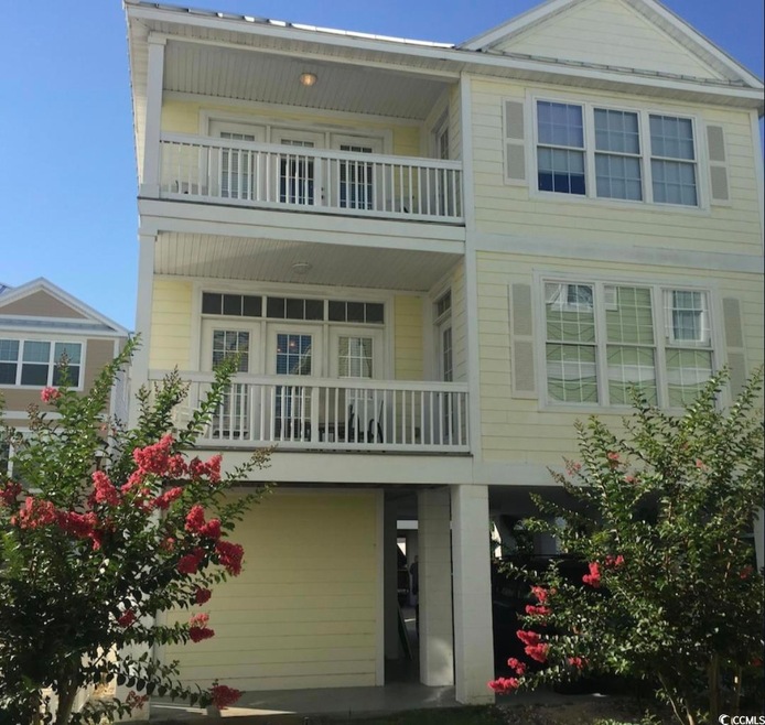 View of front of house with a balcony
