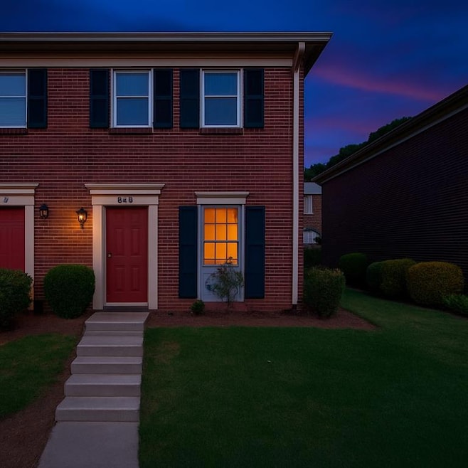 Colonial inspired home with a front yard and brick siding