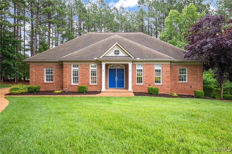 View of front of property with a front yard, roof