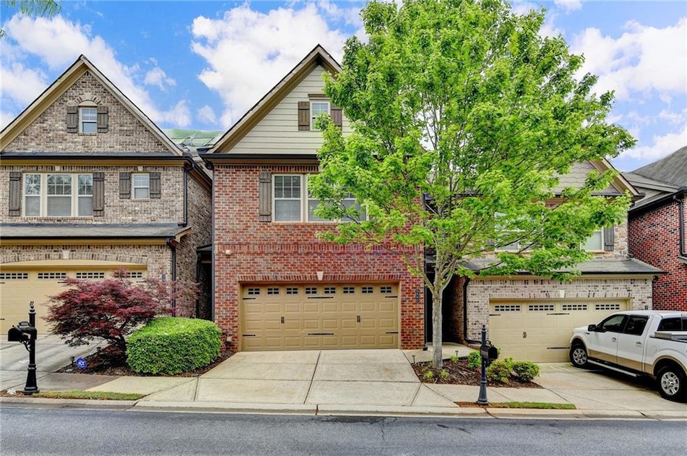 Multi unit property featuring a garage, brick sidi