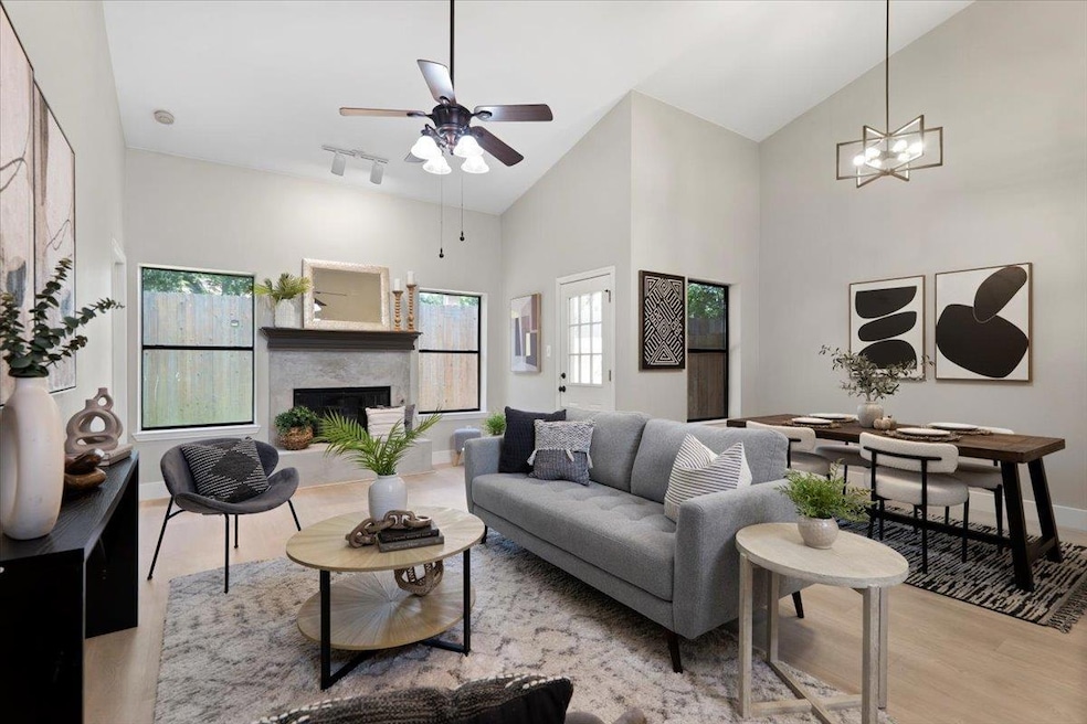 Living room with light wood-style flooring, a hig