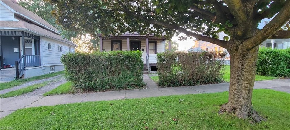 Obstructed view of property with a front lawn